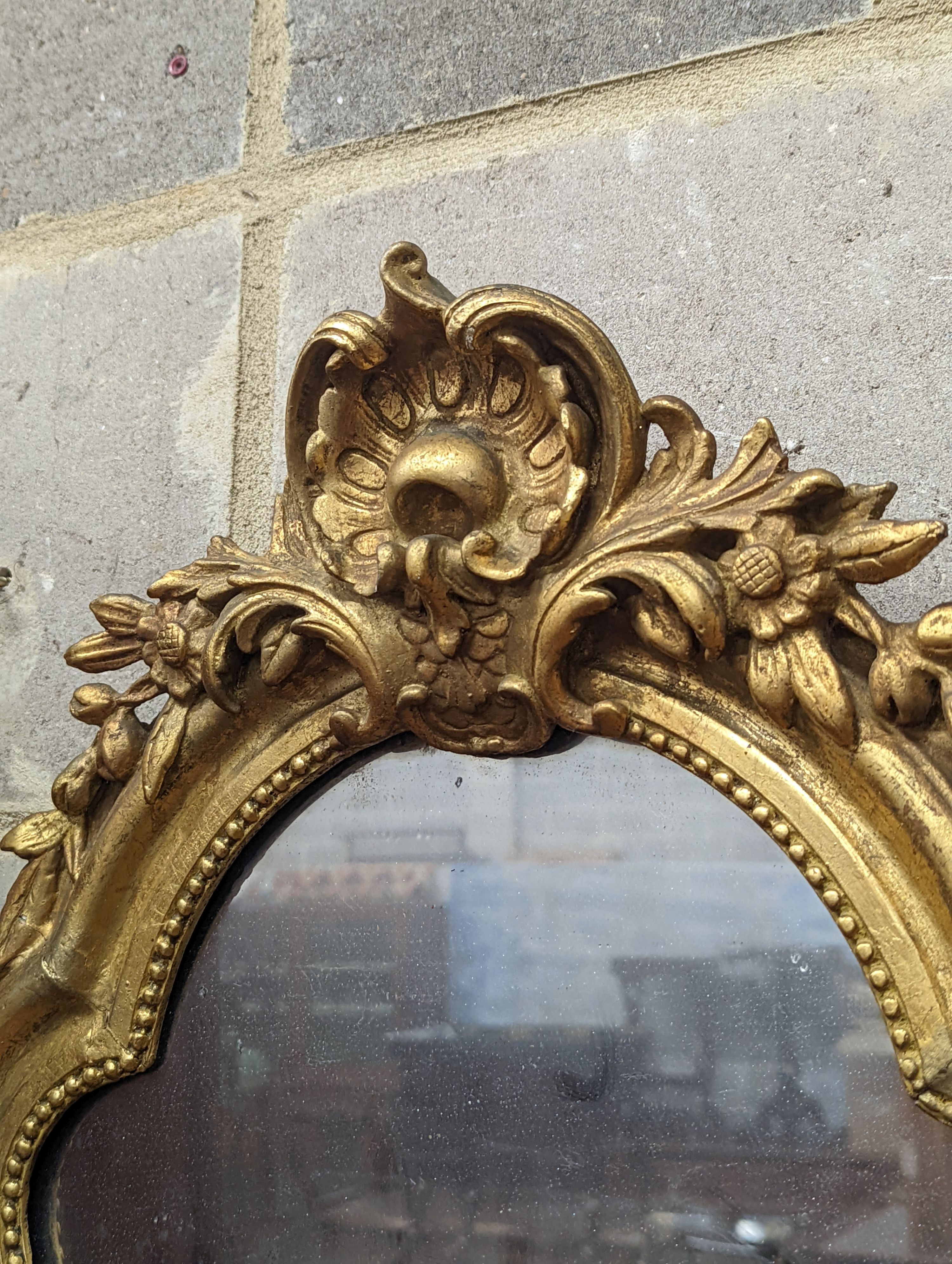 A 19th century French giltwood and gesso cartouche wall mirror, width 51cm, height 66cm